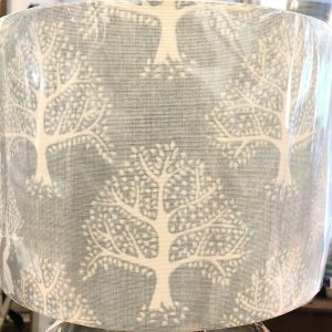 Lampshade, white trees on pale blue background