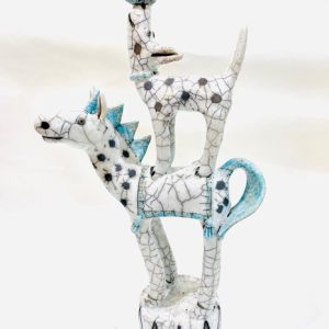 Handmade stoneware raku fired spotty dog, standing on the back of a horse