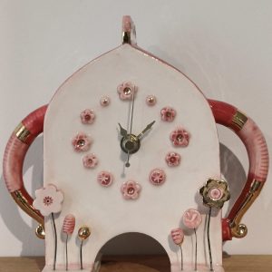 Ceramic clock with pink and gold floral details