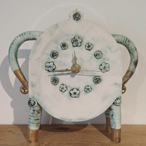Ceramic clock with pale green and gold floral details